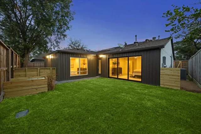 a view of a backyard with a garden and deck