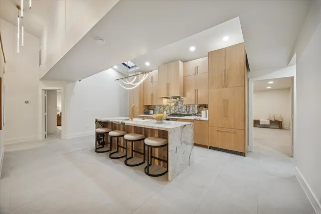 a kitchen with a table chairs sink and stove