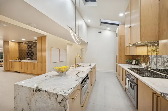 a spacious bedroom with a bed and a large window