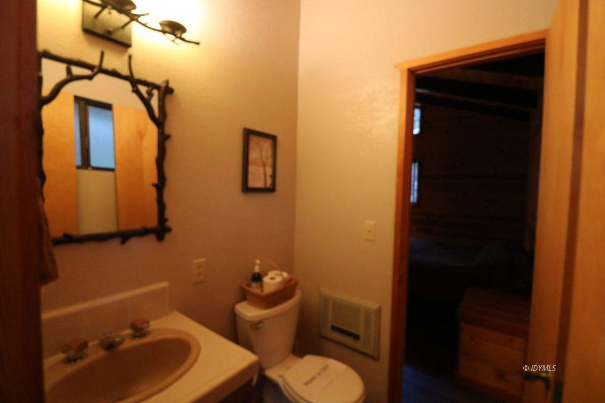 24796 Fern Valley Road Idyllwild, CA 92549 - Photo 14 of 20 a bathroom with a sink toilet and mirror