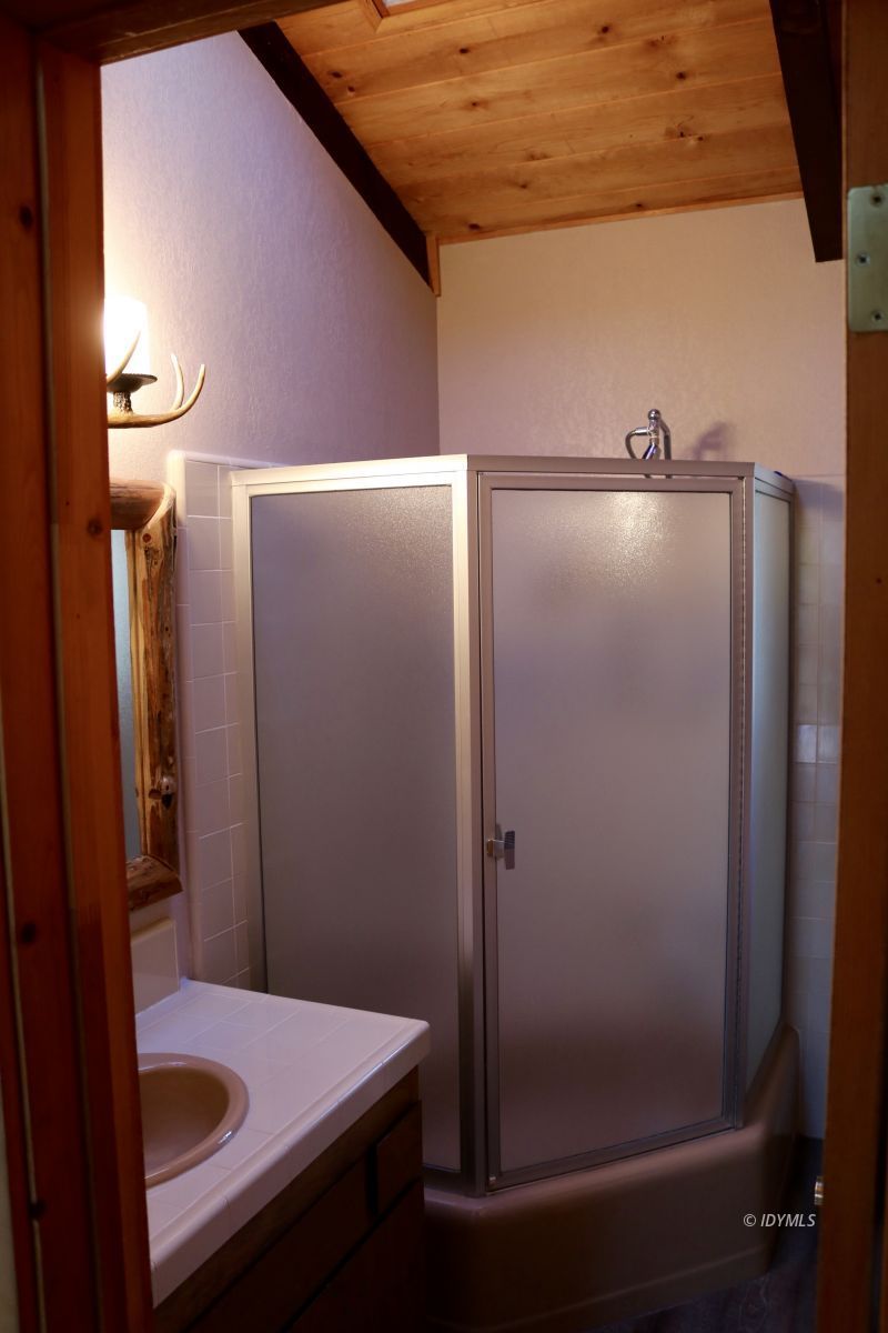 24796 Fern Valley Road Idyllwild, CA 92549 - Photo 16 of 20 a bathroom with a shower and a sink