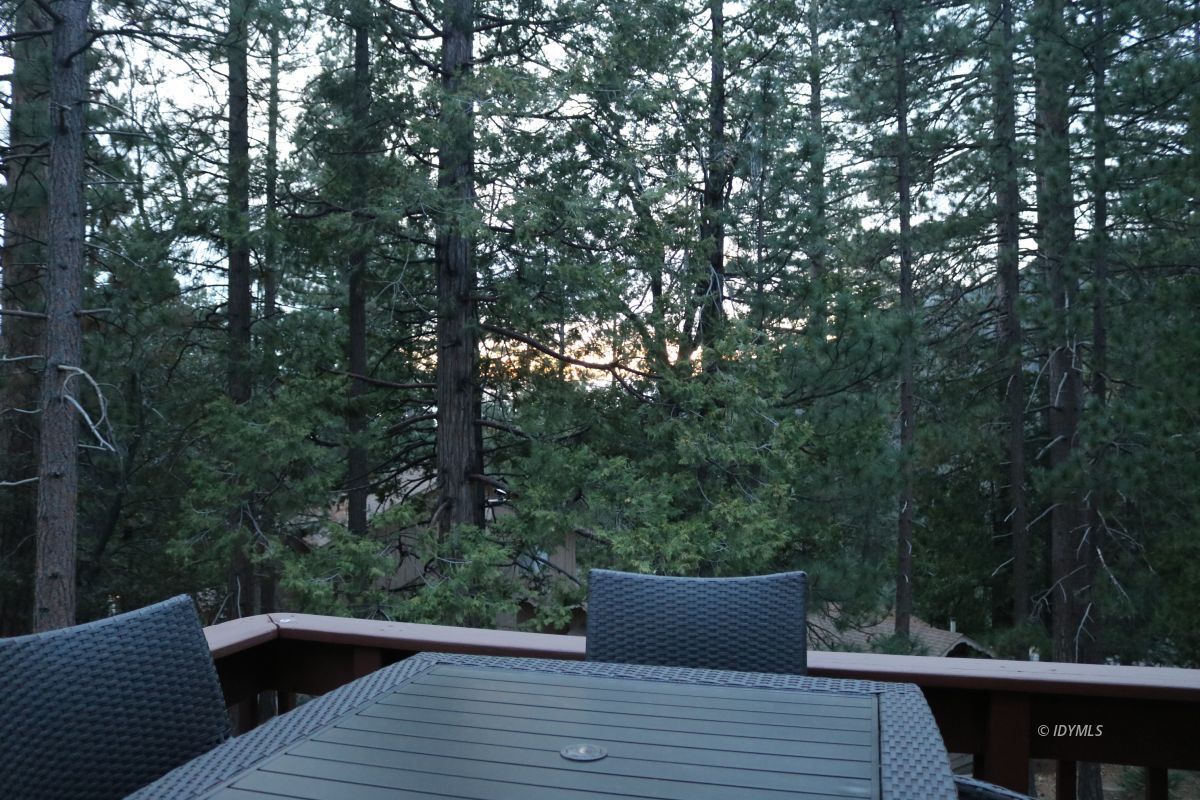 24796 Fern Valley Road Idyllwild, CA 92549 - Photo 4 of 20 a wooden deck with sunset view