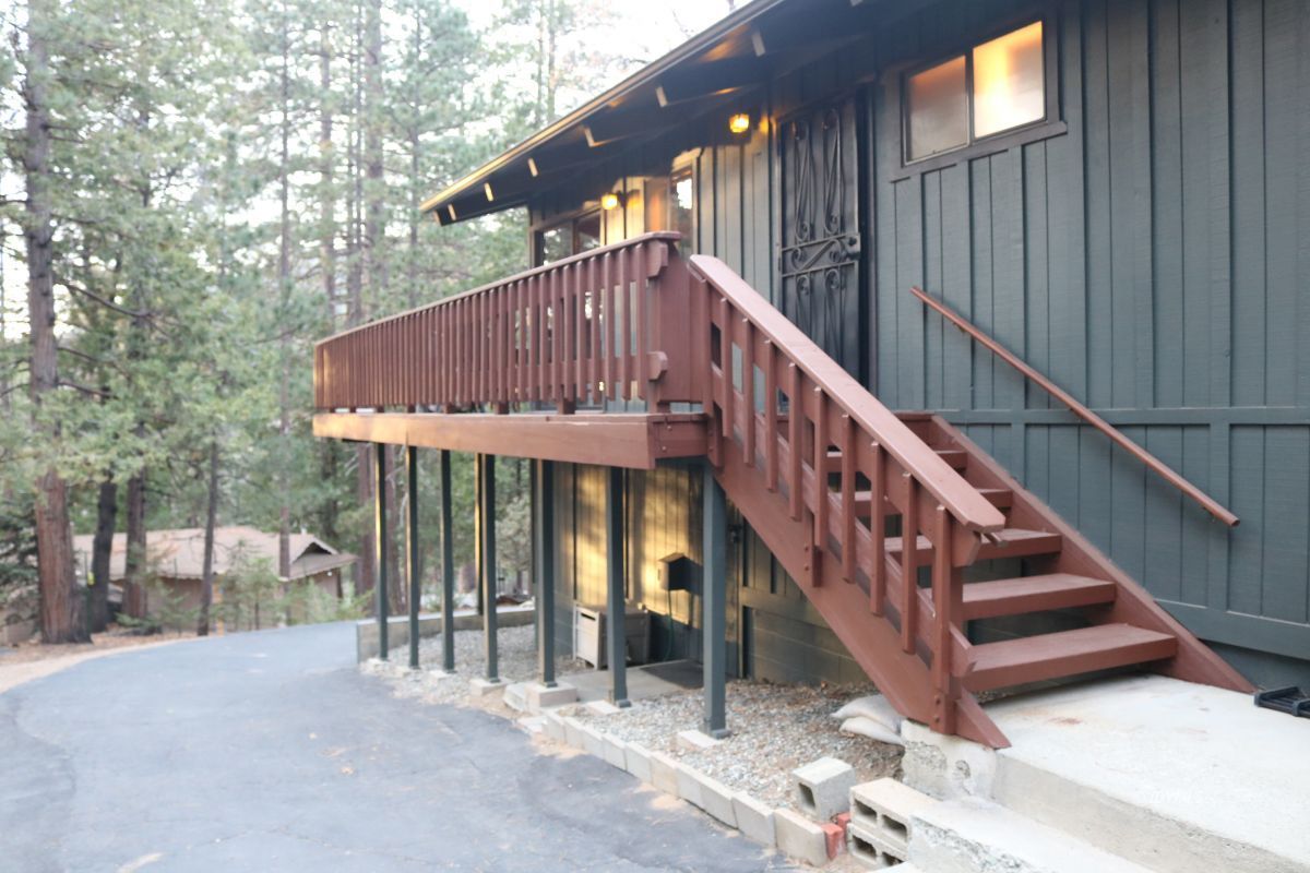 24796 Fern Valley Road Idyllwild, CA 92549 - Photo 6 of 20 a view of small house with wooden stairs and a white floor