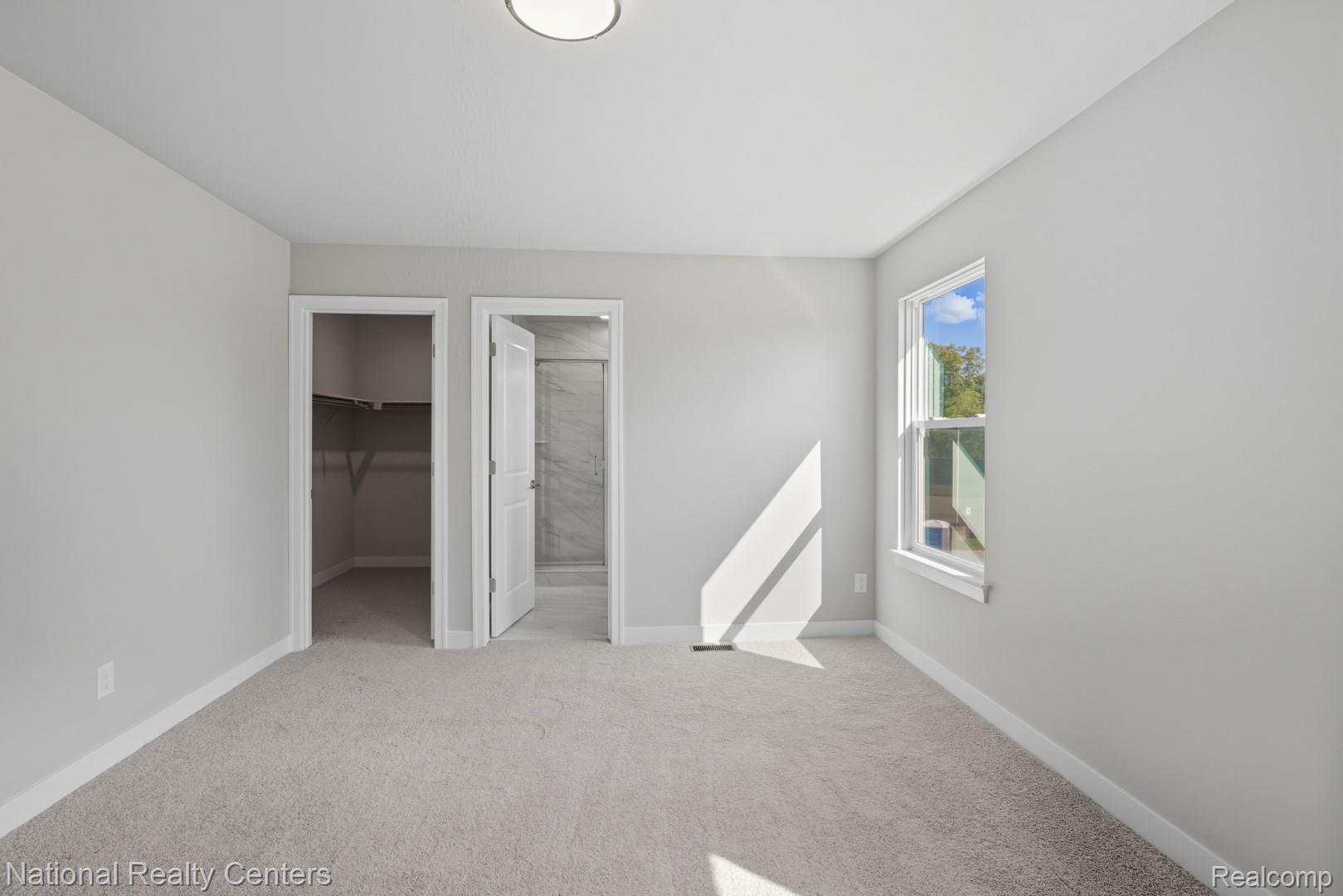 25018 Reeck Road Trenton, MI 48183 - Photo 28 of 32 Carpeted room with light gray walls, a flush-mount ceiling light, a single window, and two open doorways