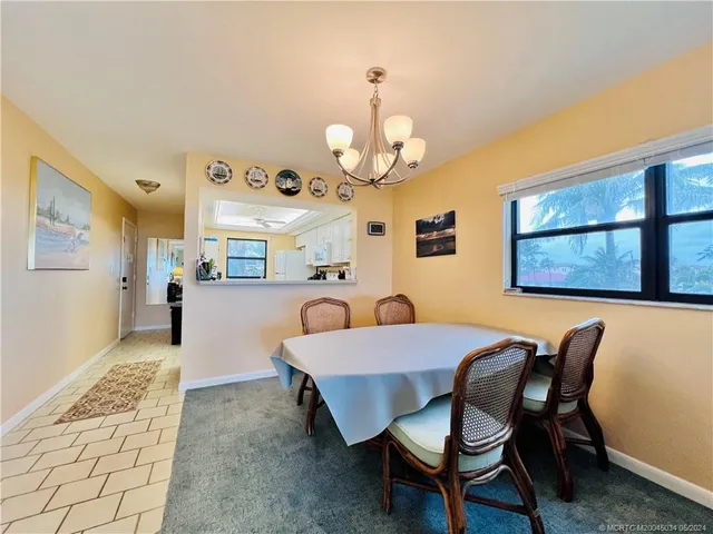 a view of a dining room with furniture and a chandelier