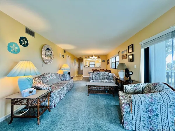 a living room with furniture and a lamp