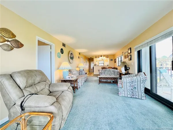 a living room with furniture and large windows
