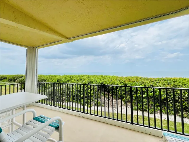 a view of a dining room with furniture and a flat screen tv