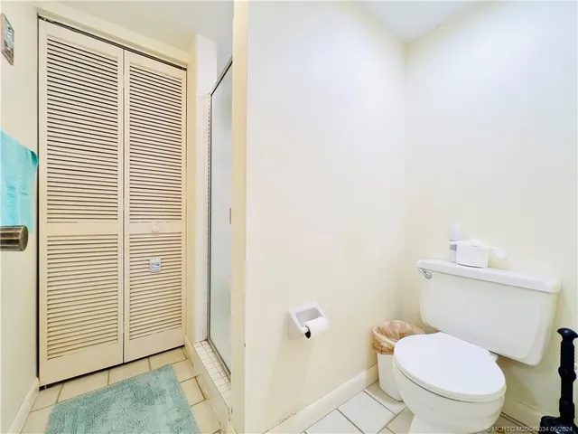 a bathroom with a double vanity sink toilet and a tub