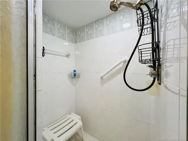 a en suite bathroom with a sink and mirror with bathtub