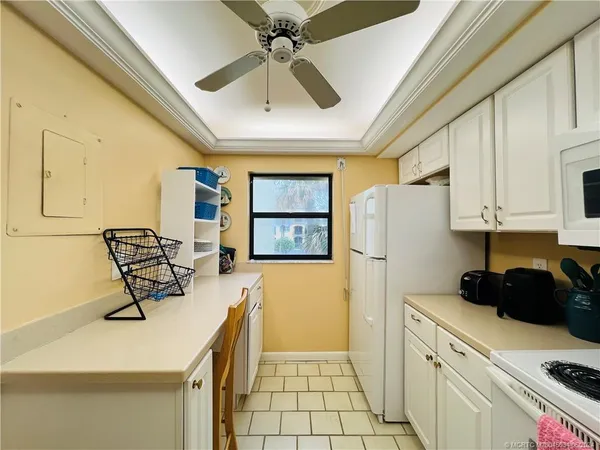 a kitchen with a refrigerator a stove top oven a sink and dishwasher