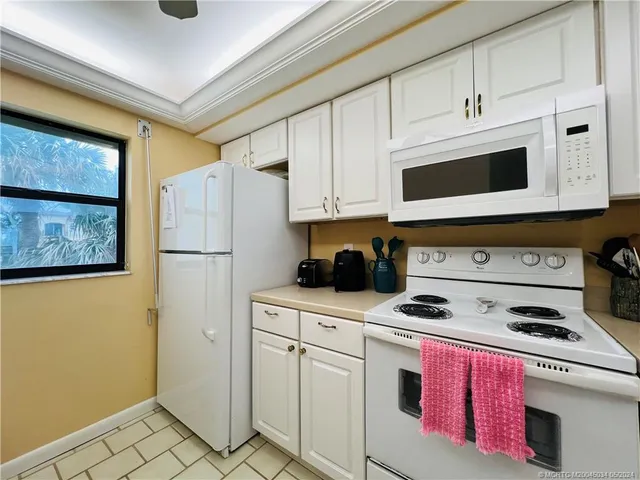 a kitchen with cabinets appliances and a counter space