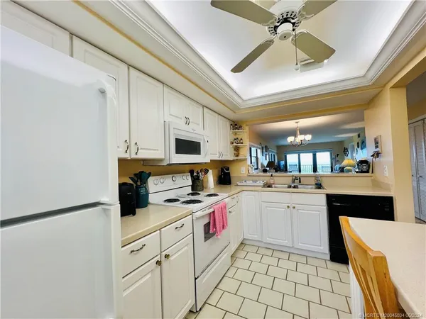 a kitchen with stainless steel appliances a stove refrigerator sink and cabinets