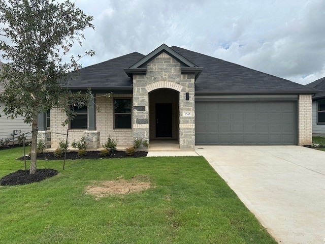 150 Spirit Street Elgin, TX 78621 - Photo 1 of 1 a front view of a house with a garden
