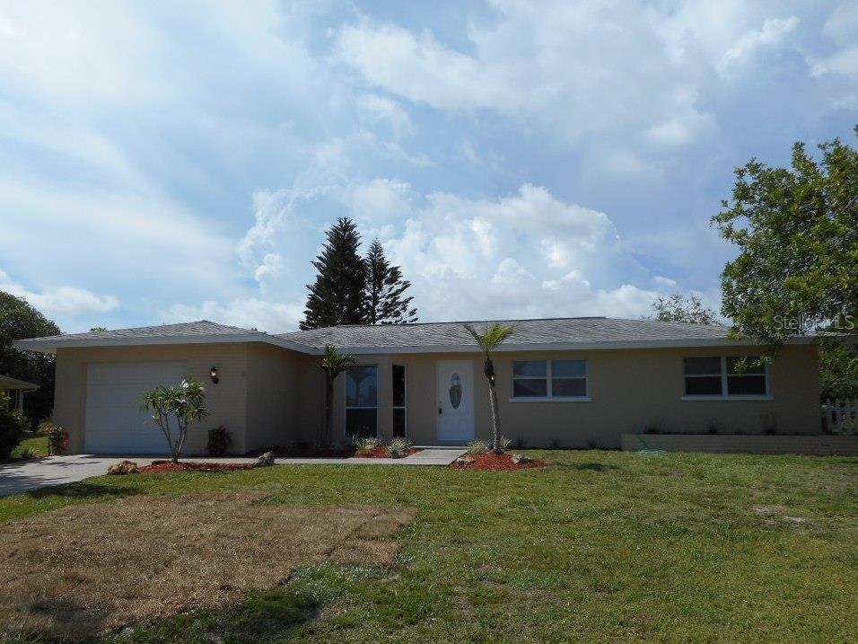 263 Caddy Road Rotonda West, FL 33947 - Photo 1 of 1 a view of a house with backyard and garden