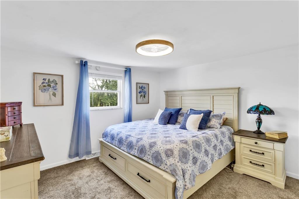 212 Seanor Road Irwin, PA 15642 - Photo 17 of 33 13x12 Primary Bedroom with Neutral Carpet, Fresh Paint, Updated Dimmable, 6 Speed, 24' Fandelier.