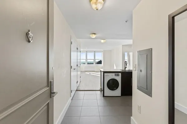 a kitchen with granite countertop a refrigerator and a sink