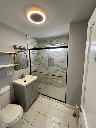 a bathroom with a sink toilet and shower