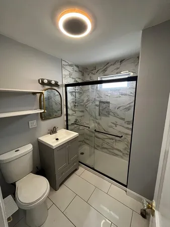 a bathroom with a toilet sink and shower