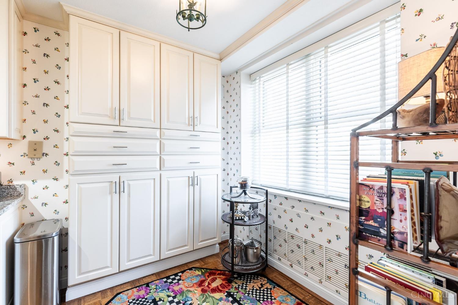 2444 Madison Road, Unit 901 Cincinnati, OH 45208 - Photo 12 of 44 The updated and well-equipped kitchen boasts an abundance of crisp white cabinetry trimmed with crown molding, a convenient walk-in pantry, granite countertops, stainless steel appliances and hardwood floors.