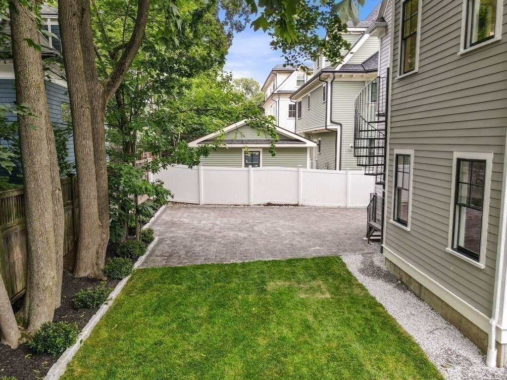 30 Naples Road, Unit 1 Brookline, MA 02446 - Photo 19 of 28 a front view of a house with a yard and garage