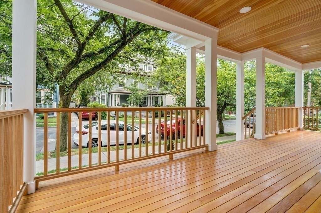30 Naples Road, Unit 1 Brookline, MA 02446 - Photo 23 of 28 a view of a porch with wooden floor and floor to ceiling windows