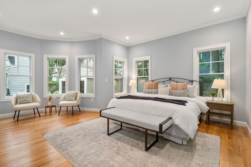 30 Naples Road, Unit 1 Brookline, MA 02446 - Photo 9 of 28 a bedroom with a bed a table and chair