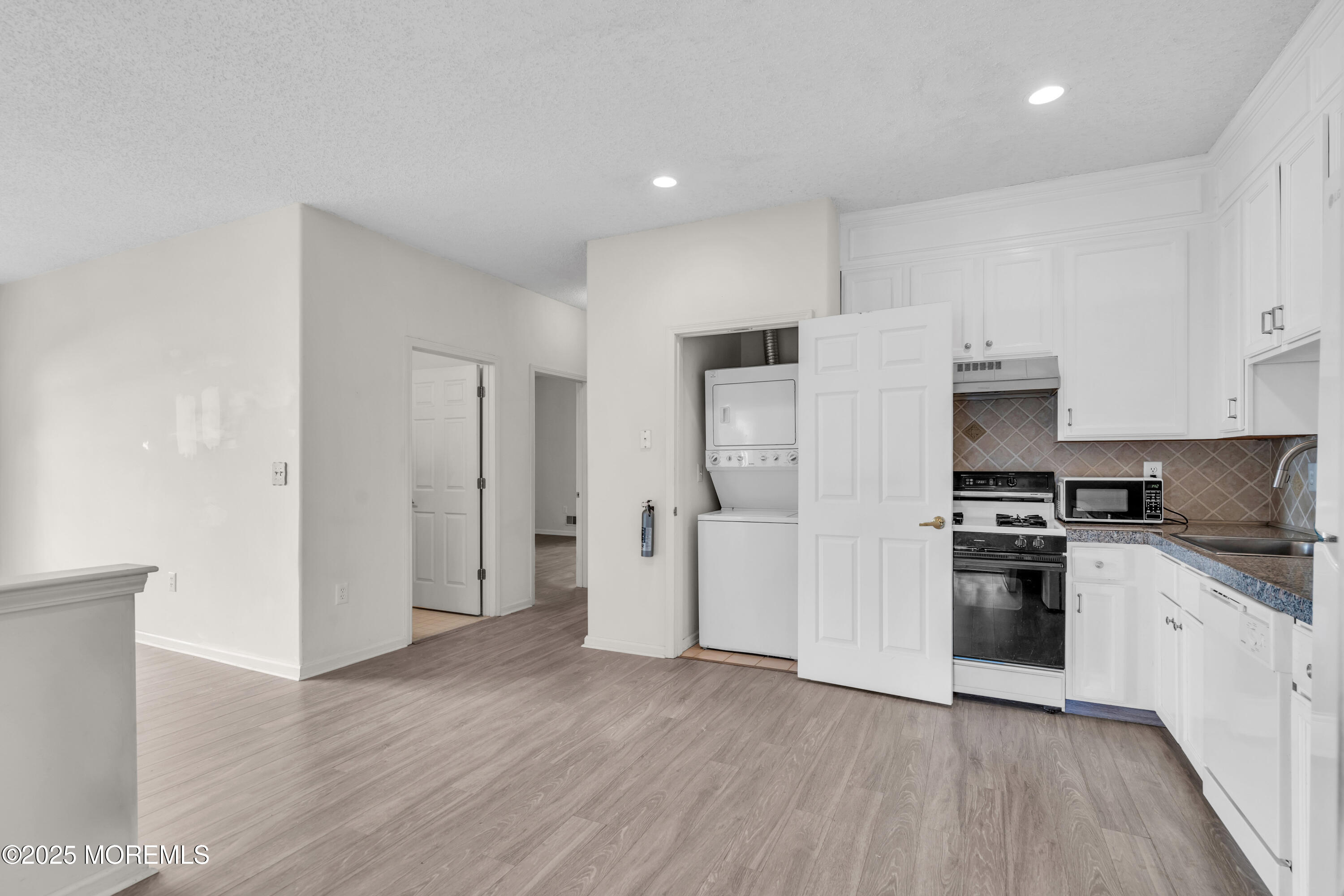 32 Riva Boulevard, Unit 2277 Brick, NJ 08723 - Photo 12 of 23 a kitchen with stainless steel appliances granite countertop a refrigerator and a stove top oven