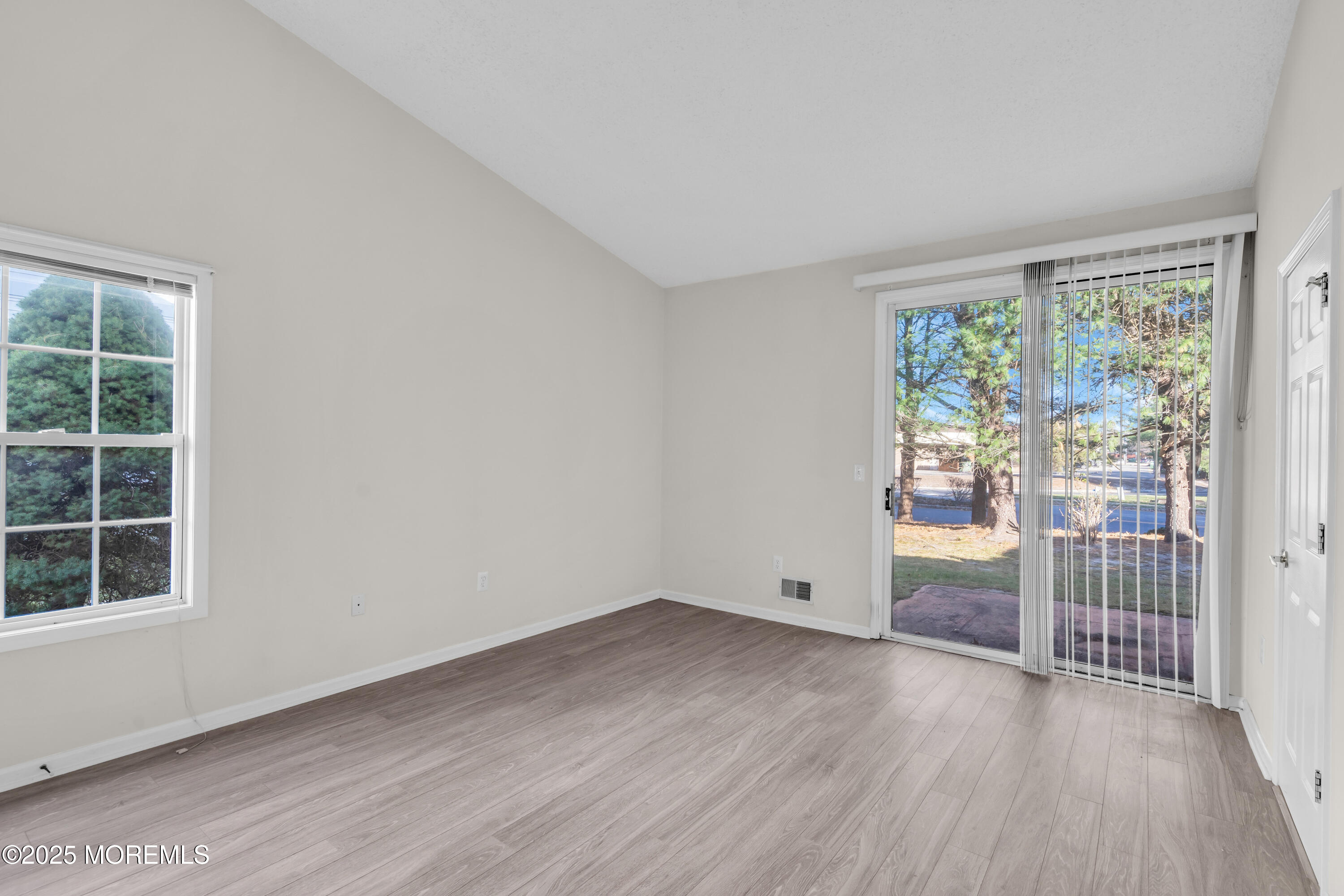 32 Riva Boulevard, Unit 2277 Brick, NJ 08723 - Photo 17 of 23 an empty room with wooden floor and windows