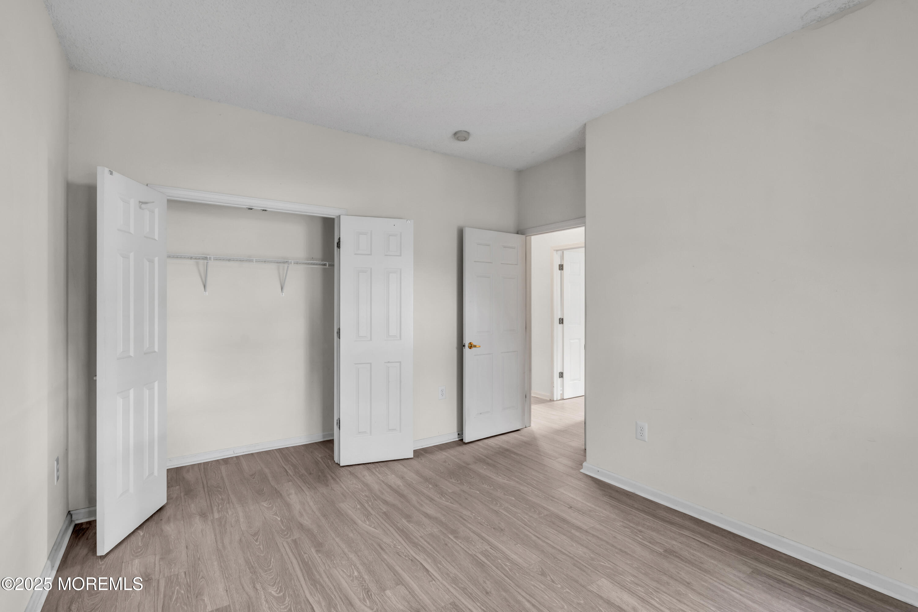 32 Riva Boulevard, Unit 2277 Brick, NJ 08723 - Photo 18 of 23 a view of an empty room with wooden floor