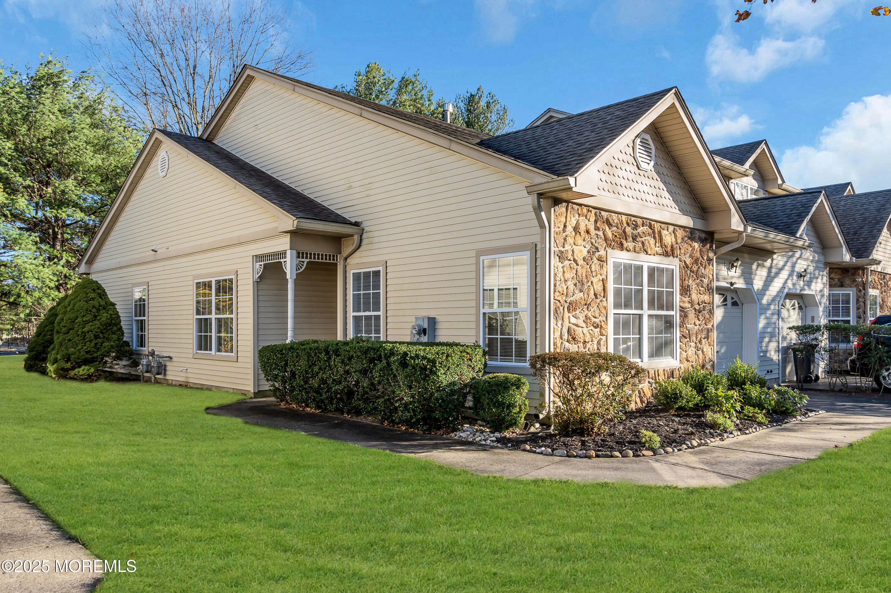 32 Riva Boulevard, Unit 2277 Brick, NJ 08723 - Photo 2 of 23 a front view of a house with a yard and potted plants