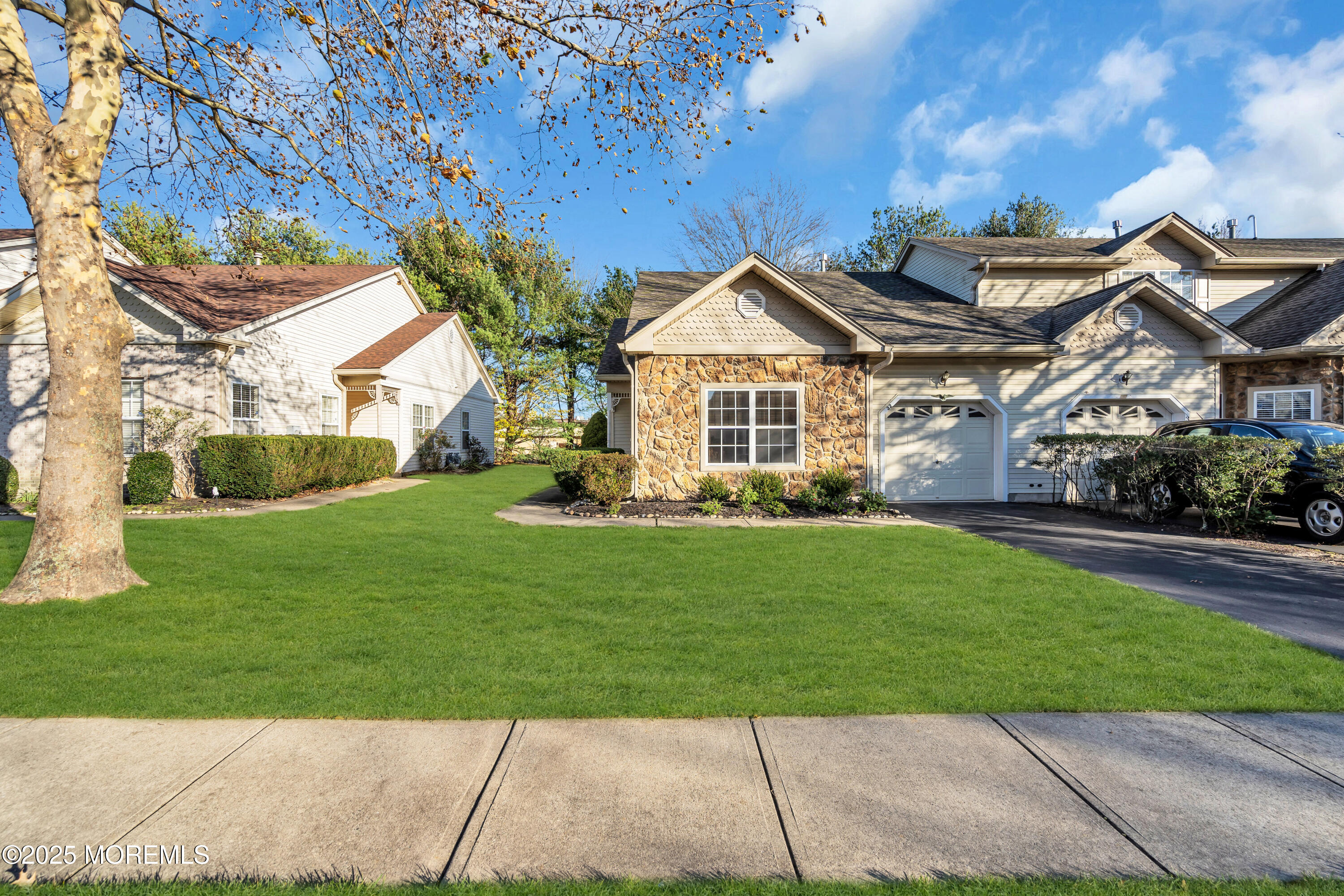 32 Riva Boulevard, Unit 2277 Brick, NJ 08723 - Photo 3 of 23 a front view of a house with a garden