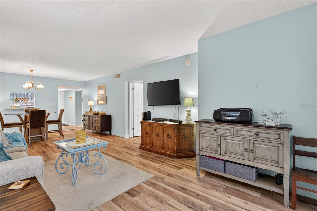 1430 Heather Ridge Boulevard, Unit 101 Dunedin, FL 34698 - Photo 11 of 44 a living room with furniture and a flat screen tv