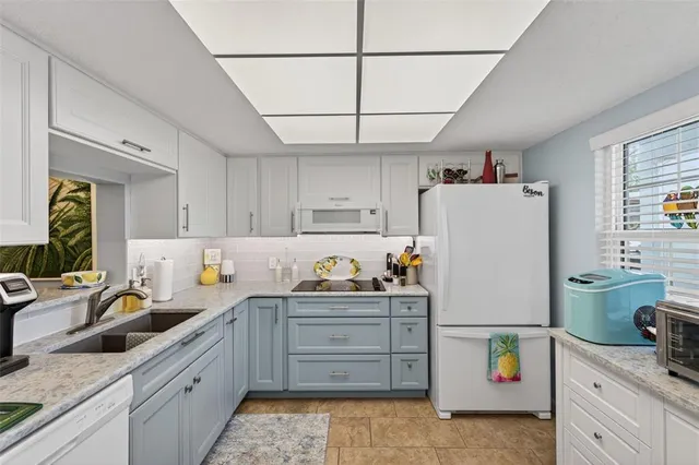 a utility room with cabinets and washer dryer