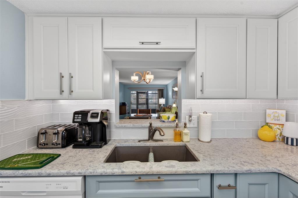 1430 Heather Ridge Boulevard, Unit 101 Dunedin, FL 34698 - Photo 18 of 44 a kitchen with a sink and cabinets