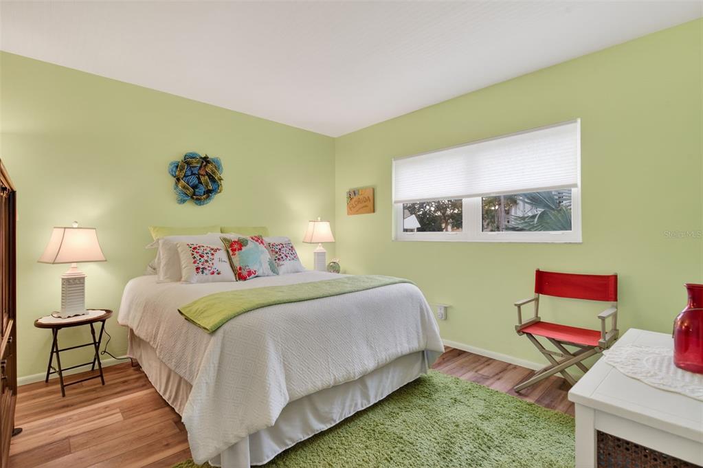 1430 Heather Ridge Boulevard, Unit 101 Dunedin, FL 34698 - Photo 21 of 44 a bed room with a bed and a chair