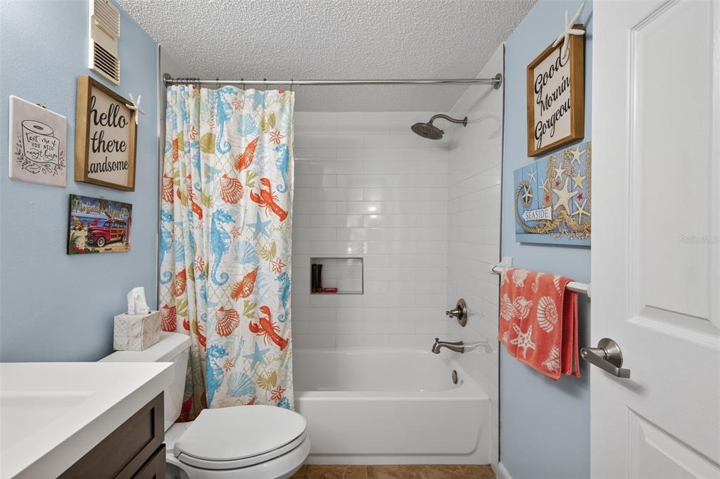 1430 Heather Ridge Boulevard, Unit 101 Dunedin, FL 34698 - Photo 24 of 44 a white toilet sitting next to a bath tub