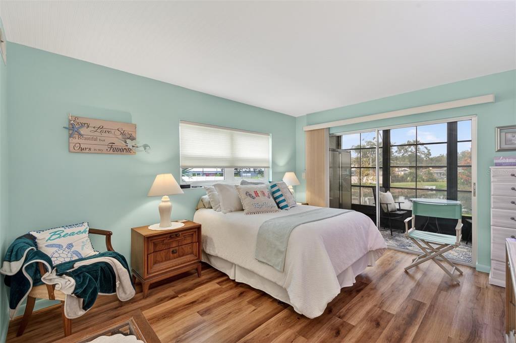 1430 Heather Ridge Boulevard, Unit 101 Dunedin, FL 34698 - Photo 25 of 44 a bedroom with a bed and a large window