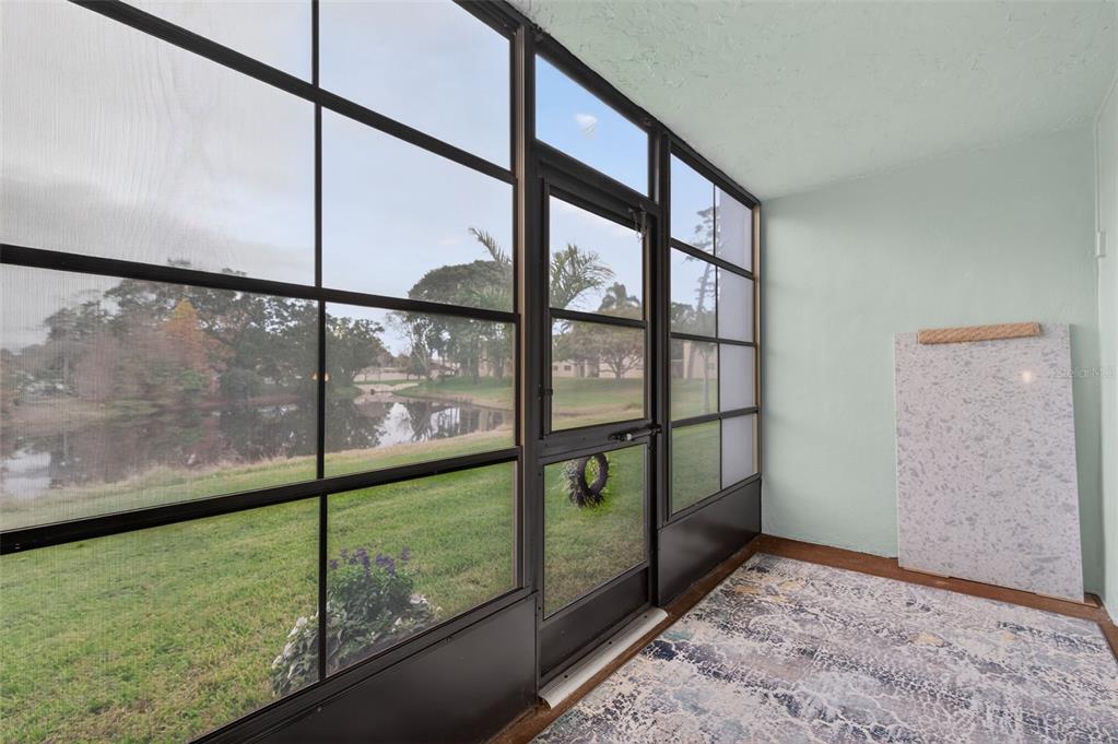 1430 Heather Ridge Boulevard, Unit 101 Dunedin, FL 34698 - Photo 32 of 44 a view of an empty room and window