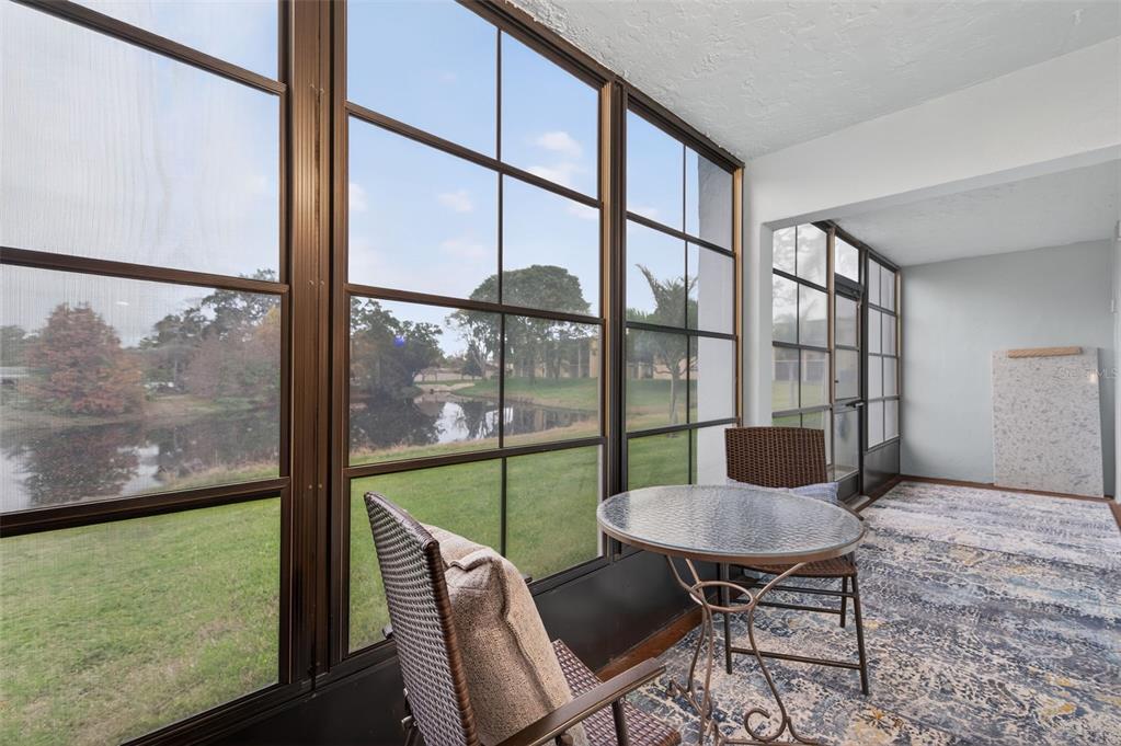 1430 Heather Ridge Boulevard, Unit 101 Dunedin, FL 34698 - Photo 33 of 44 a view of a room with a table and chairs
