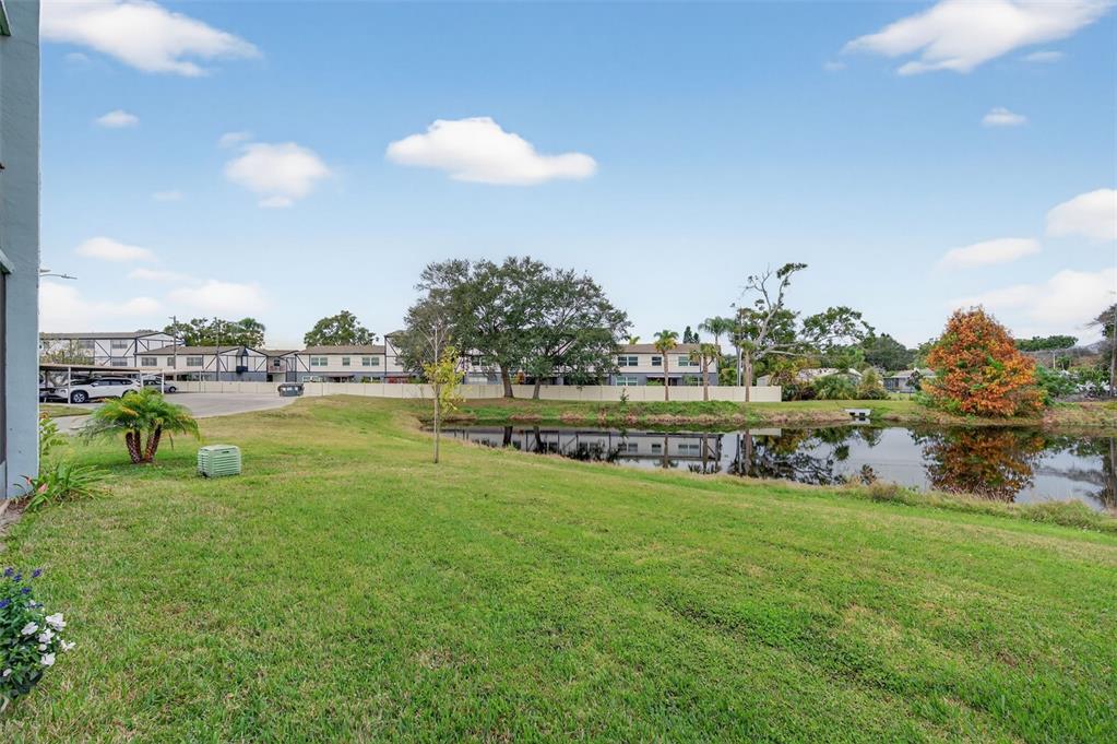 1430 Heather Ridge Boulevard, Unit 101 Dunedin, FL 34698 - Photo 34 of 44 a view of a lake with houses