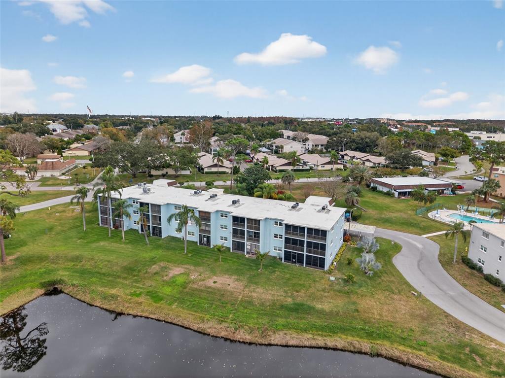 1430 Heather Ridge Boulevard, Unit 101 Dunedin, FL 34698 - Photo 38 of 44 an aerial view of a house with a garden and lake view