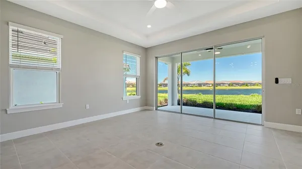 an empty room with sliding glass door and outdoor space