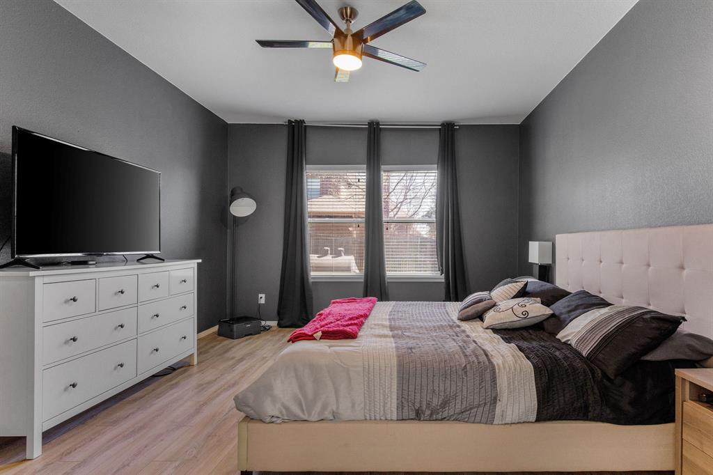 3213 Evening Wind Road Denton, TX 76208 - Photo 14 of 28 a bedroom with a bed and a flat screen tv