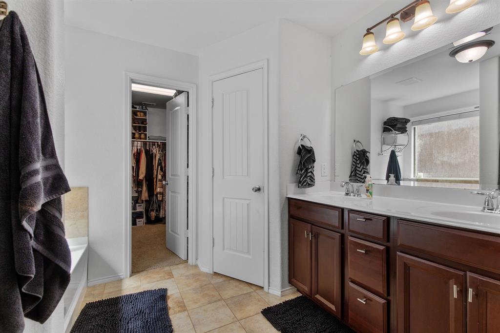 3213 Evening Wind Road Denton, TX 76208 - Photo 15 of 28 a bathroom with a double vanity sink and a mirror