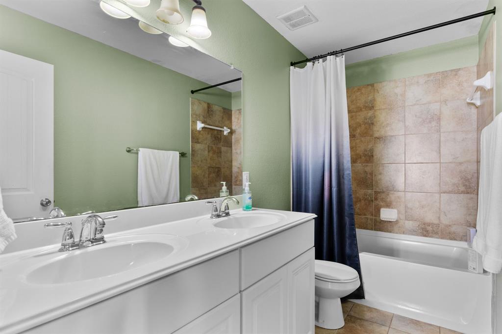3213 Evening Wind Road Denton, TX 76208 - Photo 19 of 28 a bathroom with a bathtub shower sink and toilet