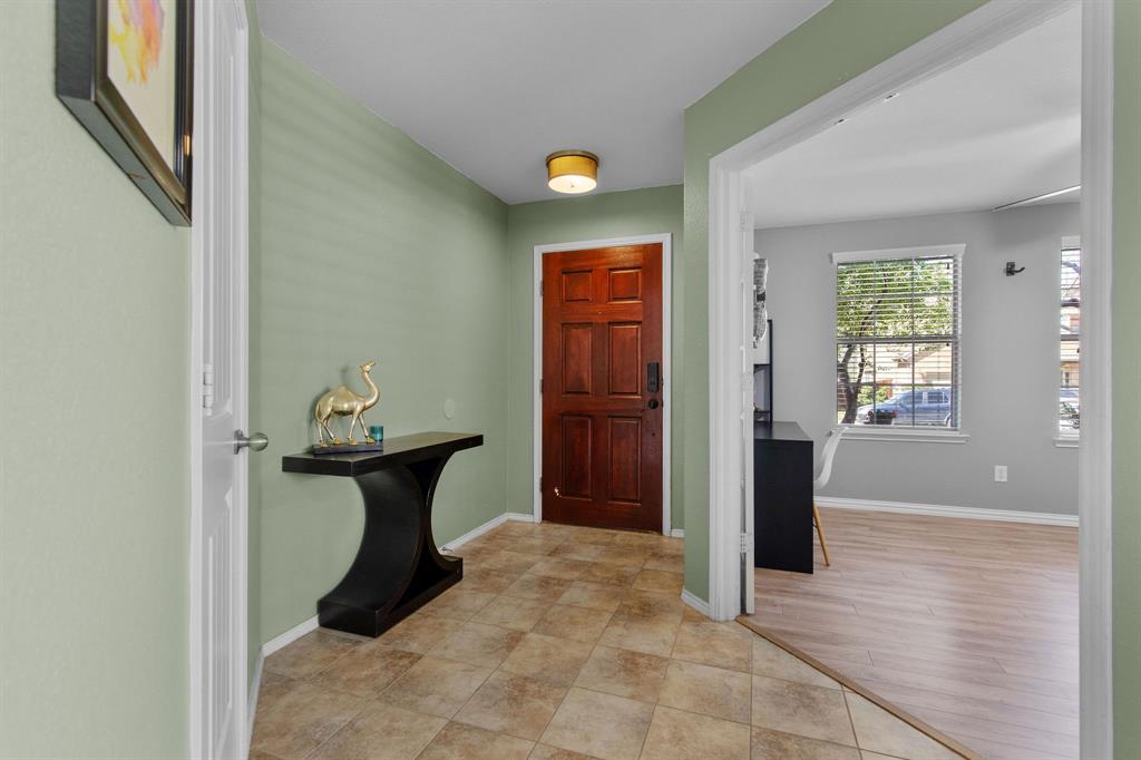 3213 Evening Wind Road Denton, TX 76208 - Photo 2 of 28 a view of a hallway with wooden floor and furniture