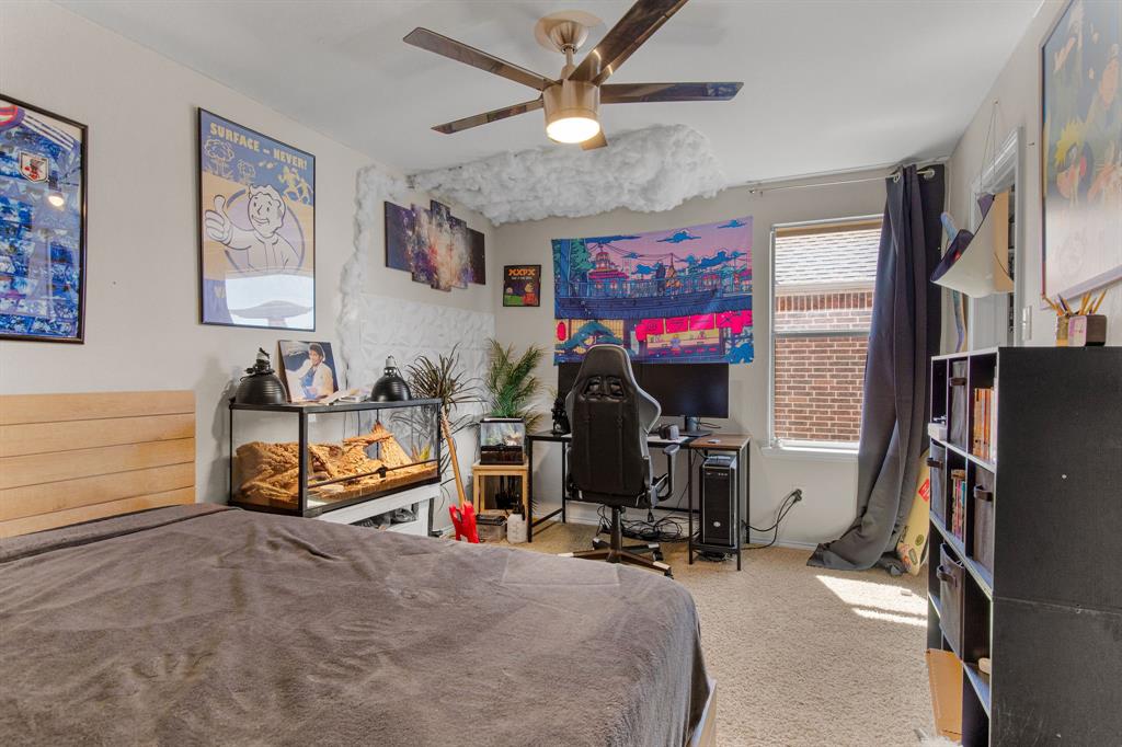 3213 Evening Wind Road Denton, TX 76208 - Photo 22 of 28 a bedroom with bed and a flat tv screen