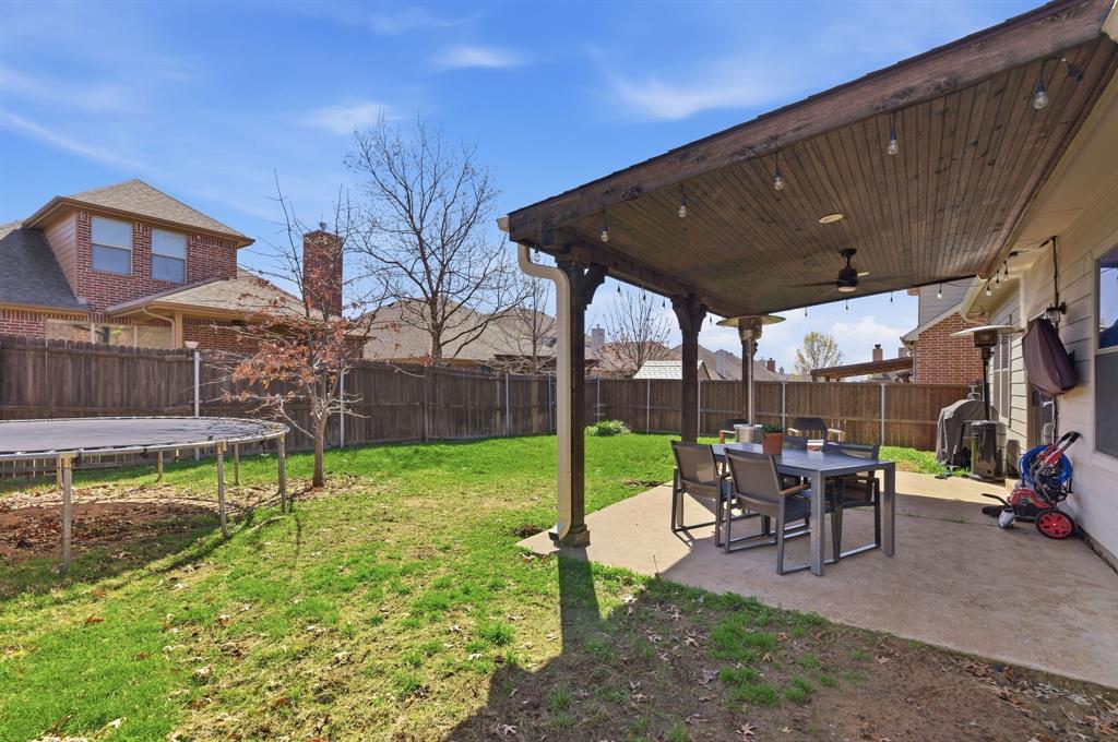 3213 Evening Wind Road Denton, TX 76208 - Photo 24 of 28 a view of a house with backyard porch and sitting area