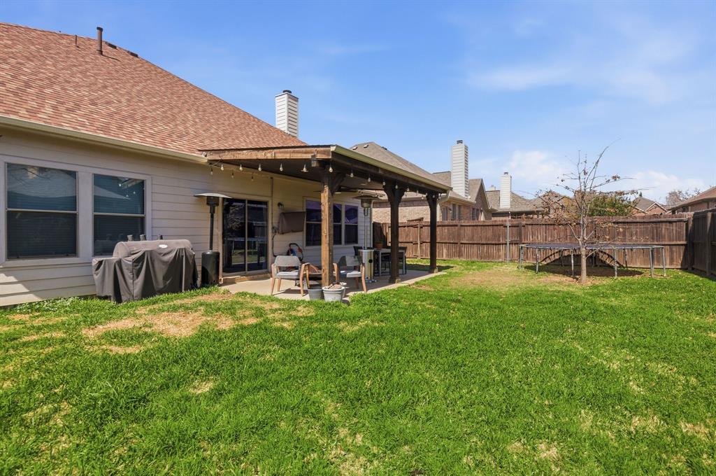 3213 Evening Wind Road Denton, TX 76208 - Photo 25 of 28 a view of a house with a yard and sitting area
